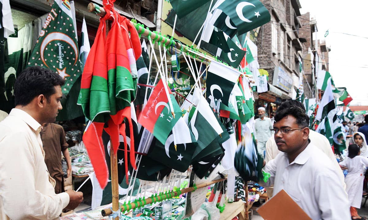 Px13-073 PESHAWAR: Aug13 – People are seen buying national flags from stalls where vendors also displayed flags of a political party ruling in the province, at Qissa Khawani Bazaar in the provincial capital. ONLINE PHOTO by Ubaid Raza